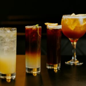 A stylish presentation of four chilled cocktails in various glasses, perfect for nightlife and social gatherings.
